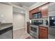 Modern kitchen features stainless steel appliances and granite countertops at 2025 E Campbell Ave # 260, Phoenix, AZ 85016
