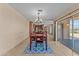 Dining room with wooden table and chairs, kitchen view, and access to patio at 1890 W Roderick Ln, Wickenburg, AZ 85390