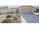 Front view of a one-story house with a two-car garage and drought-tolerant landscaping at 3649 E Hazeltine Way, Chandler, AZ 85249