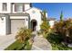 Front entrance with stone walkway, arched entryway and a bench at 26137 N 52Nd Ave, Phoenix, AZ 85083