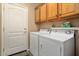 Laundry room with washer, dryer, and built-in cabinets at 22303 N Montecito Ave, Sun City West, AZ 85375