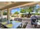 Covered patio with seating area and built-in grill at 22303 N Montecito Ave, Sun City West, AZ 85375