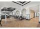 Elegant dining room with hardwood floors and stylish tables and chairs at 22303 N Montecito Ave, Sun City West, AZ 85375