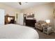 Bedroom with a king-size bed, built-in desk, and sitting area at 22303 N Montecito Ave, Sun City West, AZ 85375