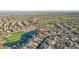 Aerial view showcasing a community with a lake, golf course, and residential homes at 22303 N Montecito Ave, Sun City West, AZ 85375