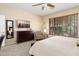 Bright bedroom with a queen-size bed and large window at 22303 N Montecito Ave, Sun City West, AZ 85375