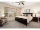 Spacious Primary bedroom with a king-size bed and large window at 22303 N Montecito Ave, Sun City West, AZ 85375