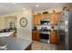 Well-equipped kitchen with wood cabinets and stainless steel appliances at 22303 N Montecito Ave, Sun City West, AZ 85375