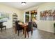 Bright dining room with wooden table and access to backyard at 22303 N Montecito Ave, Sun City West, AZ 85375