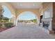 Covered patio with fireplace and golf course view at 22303 N Montecito Ave, Sun City West, AZ 85375
