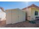White storage shed with double doors in backyard at 4622 E Flower Ave, Mesa, AZ 85206