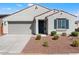 Front view of a single-story house with a two-car garage and landscaping at 15112 W Hadley St, Goodyear, AZ 85338