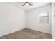 Spacious bedroom with window, ceiling fan and neutral carpeting at 15112 W Hadley St, Goodyear, AZ 85338