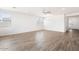 Spacious living room with wood-look tile floors and lots of natural light at 15112 W Hadley St, Goodyear, AZ 85338