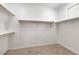 Spacious walk-in closet with ample shelving and hanging rods at 15112 W Hadley St, Goodyear, AZ 85338