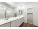 Bright bathroom boasts double sinks, a walk-in shower, and an adjacent walk-in closet at 15112 W Hadley St, Goodyear, AZ 85338