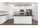 Modern kitchen with white cabinets, granite countertops and tile backsplash at 15112 W Hadley St, Goodyear, AZ 85338