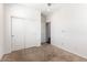 Well-lit bedroom with double door closet and neutral carpeting at 15112 W Hadley St, Goodyear, AZ 85338