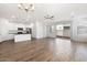 Open kitchen with white cabinets, granite island, and stainless steel appliances at 15112 W Hadley St, Goodyear, AZ 85338