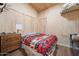 Simple bedroom with wood walls and a red blanket on the bed at 52108 N 461St. Ave, Wickenburg, AZ 85390