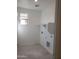 Laundry room with overhead shelving and tile flooring at 20542 N 226Th Ln, Surprise, AZ 85387