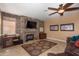 Comfortable living room featuring a stone fireplace and built-in entertainment center at 753 E Mountain Sky Ave, Phoenix, AZ 85048