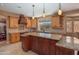 Spacious kitchen with light wood cabinets, granite countertops, and an island at 753 E Mountain Sky Ave, Phoenix, AZ 85048