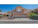 Two-story house with tan stucco exterior, two-car garage, and manicured landscaping at 753 E Mountain Sky Ave, Phoenix, AZ 85048