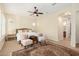 Bright bedroom with ensuite bathroom access and ceiling fan at 5088 S Ponderosa Dr, Gilbert, AZ 85298