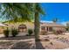 Single story home with rock landscaping and mature tree at 12407 W Foxfire Dr, Sun City West, AZ 85375