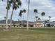 View of a lush green golf course with palm trees and mountains in the background at 2661 N Higley Rd, Mesa, AZ 85215