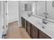 Double vanity bathroom with dark brown cabinets and tile floor at 2199 E Gillcrest Rd, Gilbert, AZ 85298