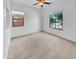 Comfortable bedroom with neutral carpeting, ceiling fan, and large window at 2199 E Gillcrest Rd, Gilbert, AZ 85298