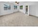 Spacious bedroom with plush carpeting, ceiling fan, and access to a private patio at 2199 E Gillcrest Rd, Gilbert, AZ 85298