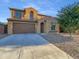 Two-story home with a brown garage door and landscaped yard at 2199 E Gillcrest Rd, Gilbert, AZ 85298