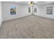 Spacious bedroom with carpeted floors and multiple windows at 2199 E Gillcrest Rd, Gilbert, AZ 85298