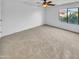 Well-lit bedroom with ceiling fan and carpet at 2199 E Gillcrest Rd, Gilbert, AZ 85298