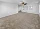 Spacious carpeted bedroom with ceiling fan and multiple windows at 2199 E Gillcrest Rd, Gilbert, AZ 85298