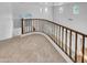 Loft area overlooking the main floor with a wooden railing at 2199 E Gillcrest Rd, Gilbert, AZ 85298