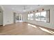 Bright dining room with hardwood floors and sliding glass doors to patio at 12911 W Blue Bonnet Dr, Sun City West, AZ 85375