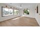 Bright dining room with hardwood floors and large windows offering natural light at 12911 W Blue Bonnet Dr, Sun City West, AZ 85375