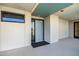 Modern condo entry with a teal door and neutral walls at 2300 E Campbell Ave # 314, Phoenix, AZ 85016