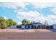 Gray house with carport, white fence, and desert landscaping at 511 E Purdue Ave, Phoenix, AZ 85020