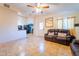 Living room with brown leather couches and tile floors at 511 E Purdue Ave, Phoenix, AZ 85020