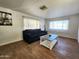 Living room with dark sofa and tile floors at 7300 N 51St Ave # F93, Glendale, AZ 85301