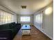 Living room with dark sofa and tile floors at 7300 N 51St Ave # F93, Glendale, AZ 85301