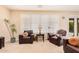 Relaxing living room with leather armchairs, a view to the backyard pool, and ample natural light at 2301 E Azalea Dr, Chandler, AZ 85286