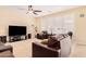 Comfortable living room featuring leather furniture, a large TV, and ample natural light at 2301 E Azalea Dr, Chandler, AZ 85286