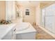 Spa-like bathroom with a large soaking tub, double vanity, and a walk-in shower at 2301 E Azalea Dr, Chandler, AZ 85286