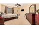 Spacious bedroom with wood furniture, a ceiling fan, and plenty of natural light at 2301 E Azalea Dr, Chandler, AZ 85286